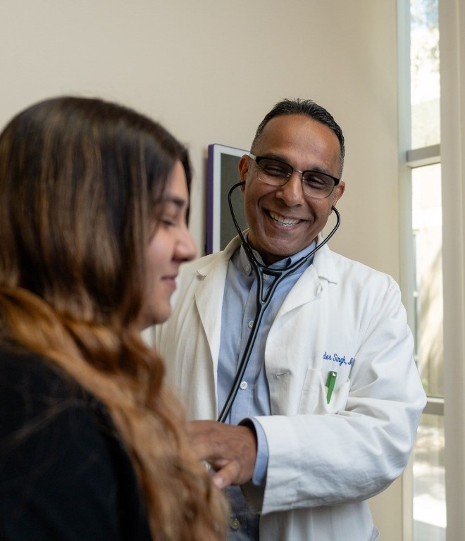 Dr. Ravinder Singh with a patient at Rancho Wellness
